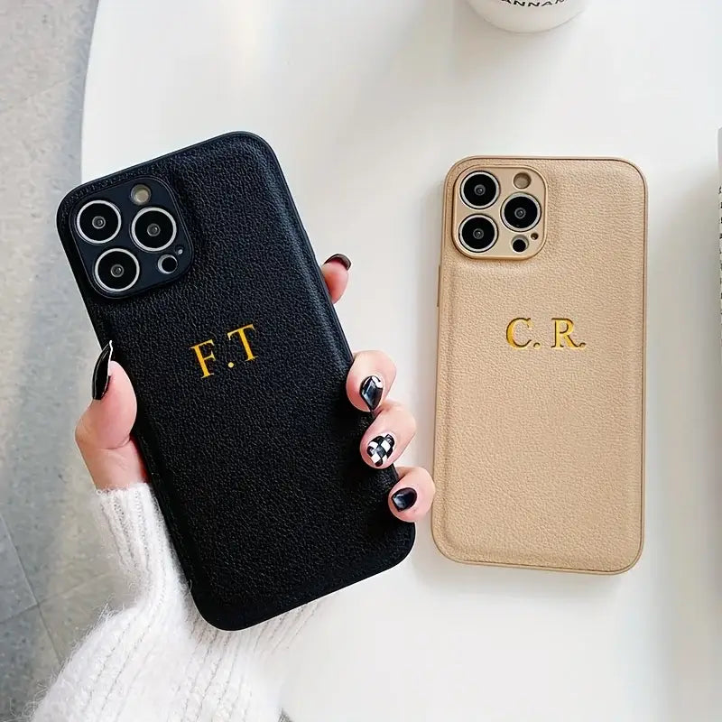 Personalized leather iPhone cases with initials F.T. and C.R. for stylish protection.
