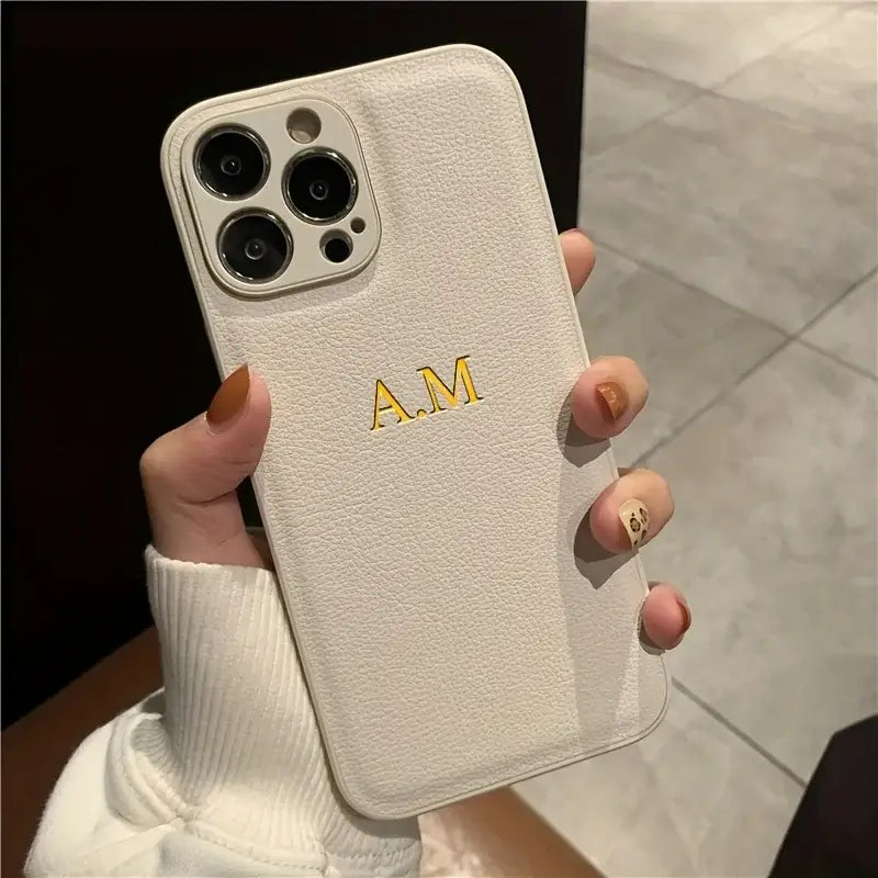 Personalized white leather iPhone case with initials A.M. for iPhone models 11 to 16 Pro Max.
