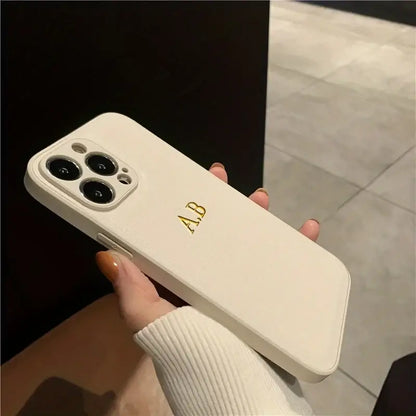 Personalized white leather iPhone case with initials A.B. for iPhone 12 13 14 15 16 Pro Max models.